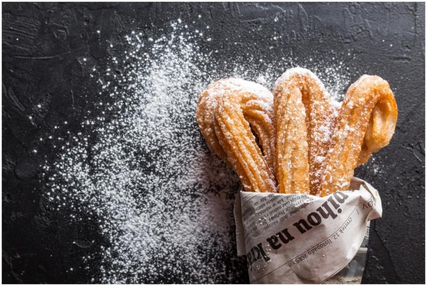 Close-up of freshly baked churros with powdered su