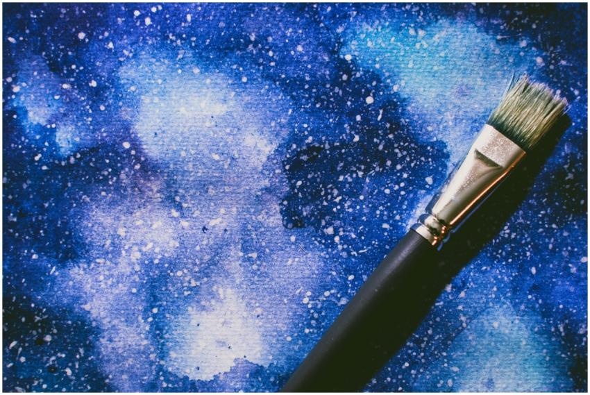 Vibrant abstract watercolor art with a paintbrush