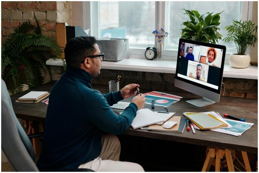 Man engaging in an online meeting from home office