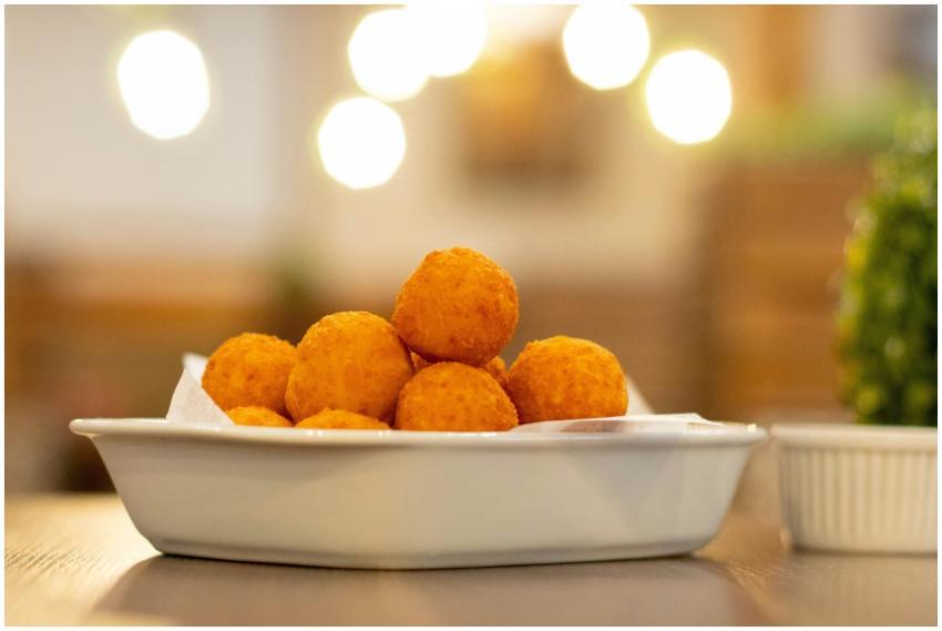 Delicious golden cheese balls served in a white di