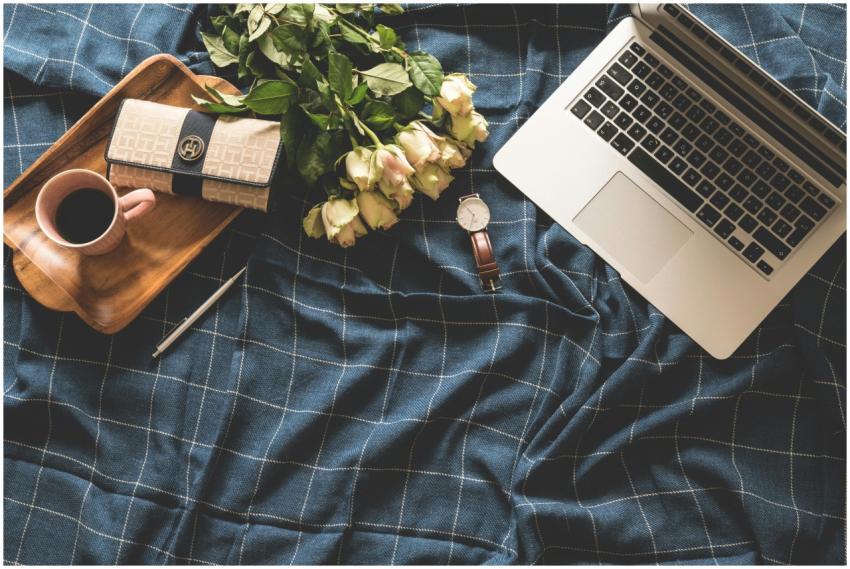 A cozy home office setup featuring a laptop, roses