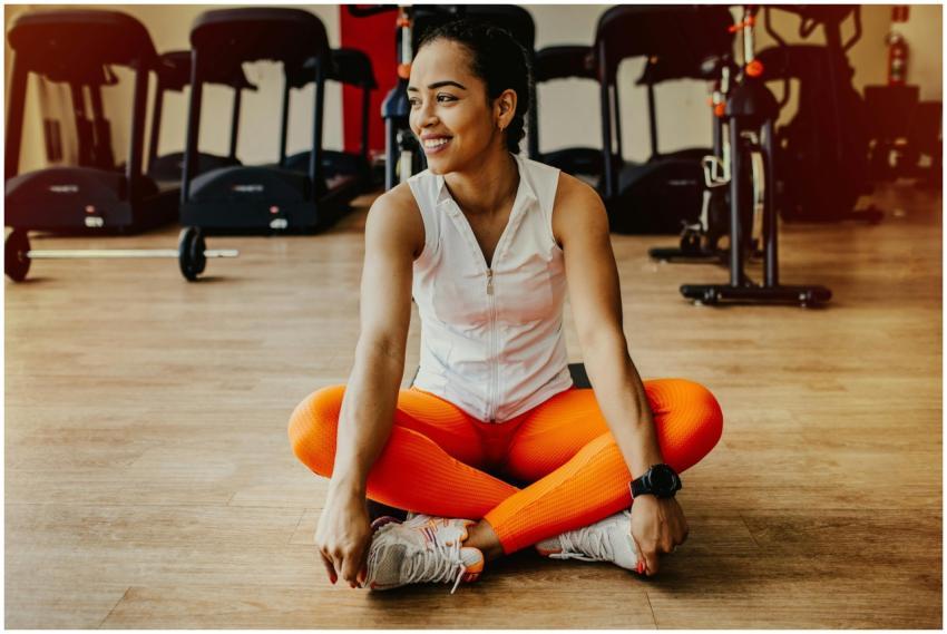 Confident woman in bright workout attire smiling w