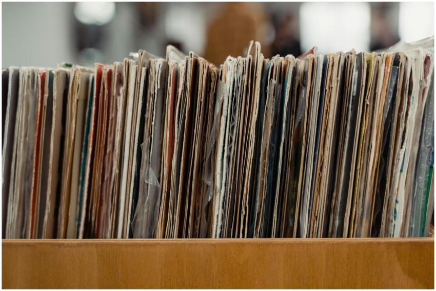 Stack of vintage vinyl records stored in a wooden