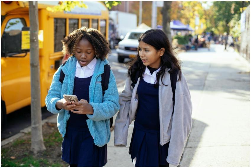 Cheerful multiracial girls classmates with backpac
