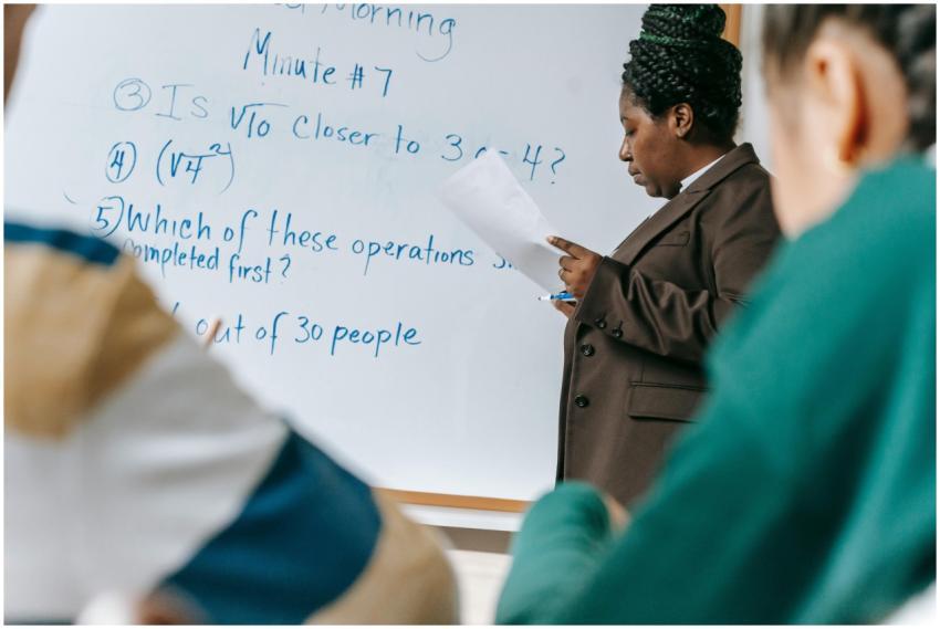 Teacher delivering a math lesson using a whiteboar