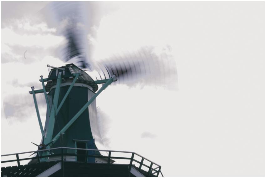 Windmill in motion with blurred blades set against