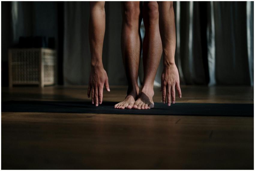 Adult man stretching during yoga session on mat in