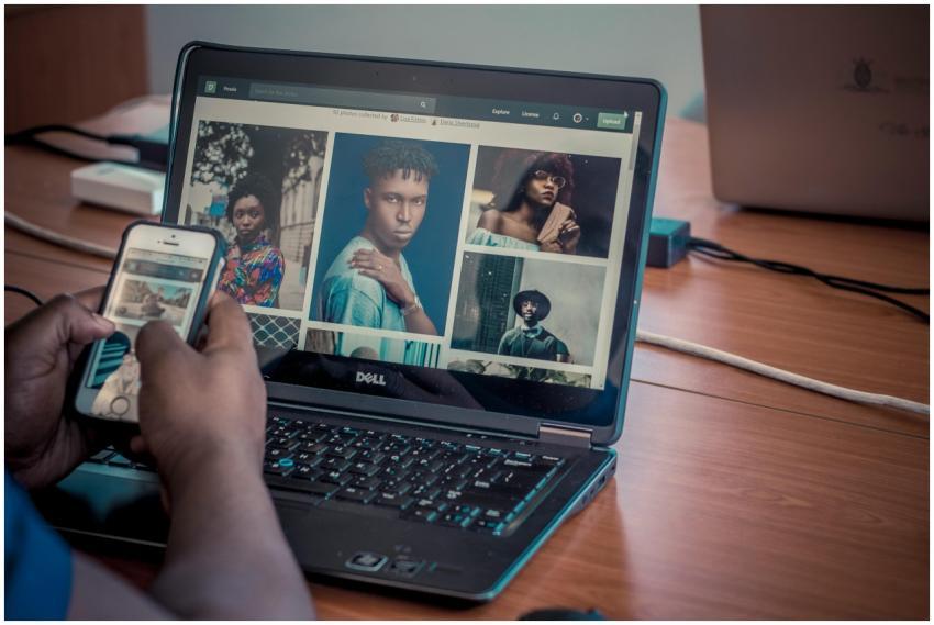 A person viewing portrait photos on a Dell laptop