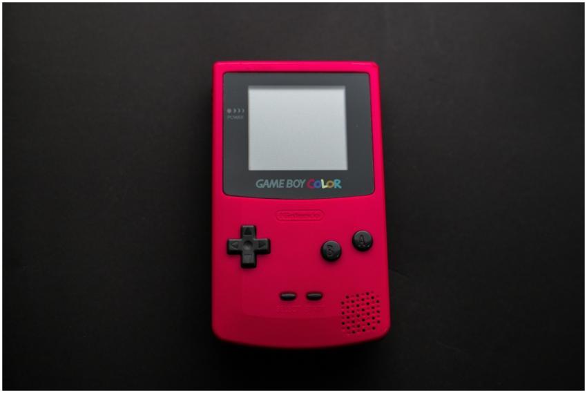 Close-up of a red Nintendo Game Boy Color on a dar