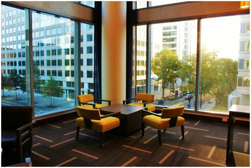 Contemporary hotel lounge featuring yellow chairs