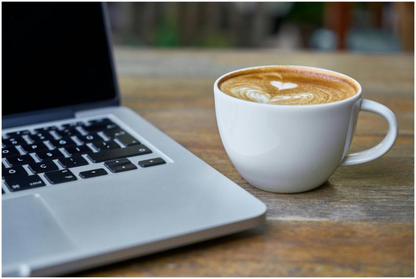 Close-up of a latte coffee with heart art next to