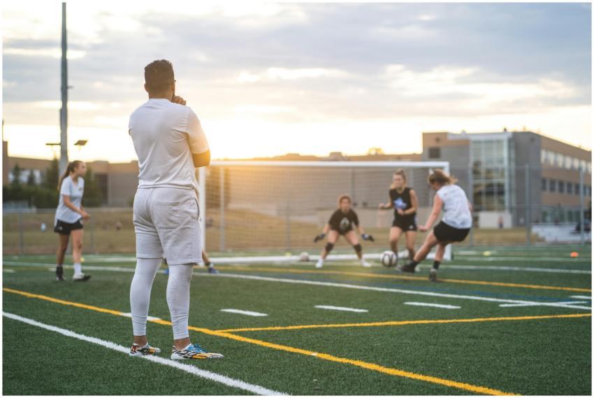 Female athletes training in soccer at sunset, focu