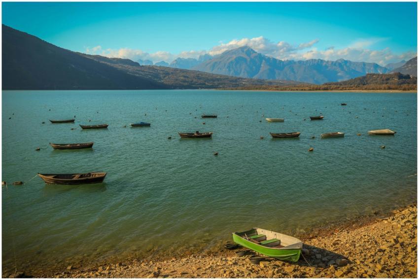 A picturesque view of a serene mountain lake with