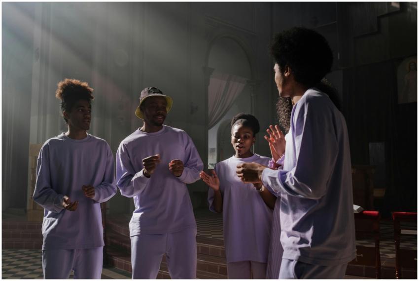 A group of choir members passionately singing in a