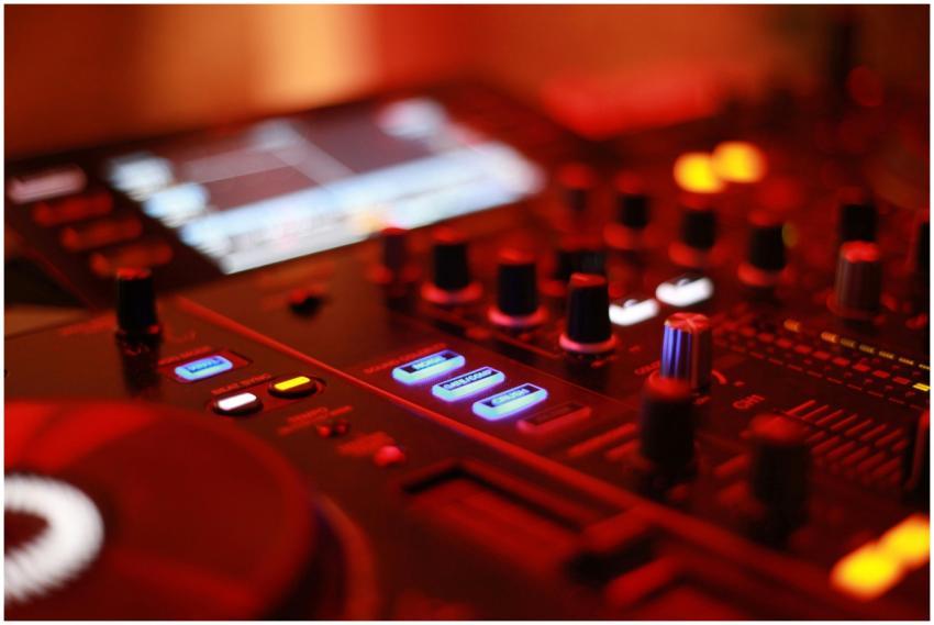 Vibrant close-up of an illuminated DJ mixing conso
