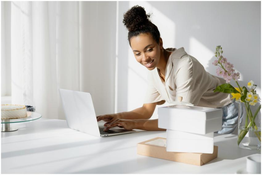 African American woman working on a laptop with bo
