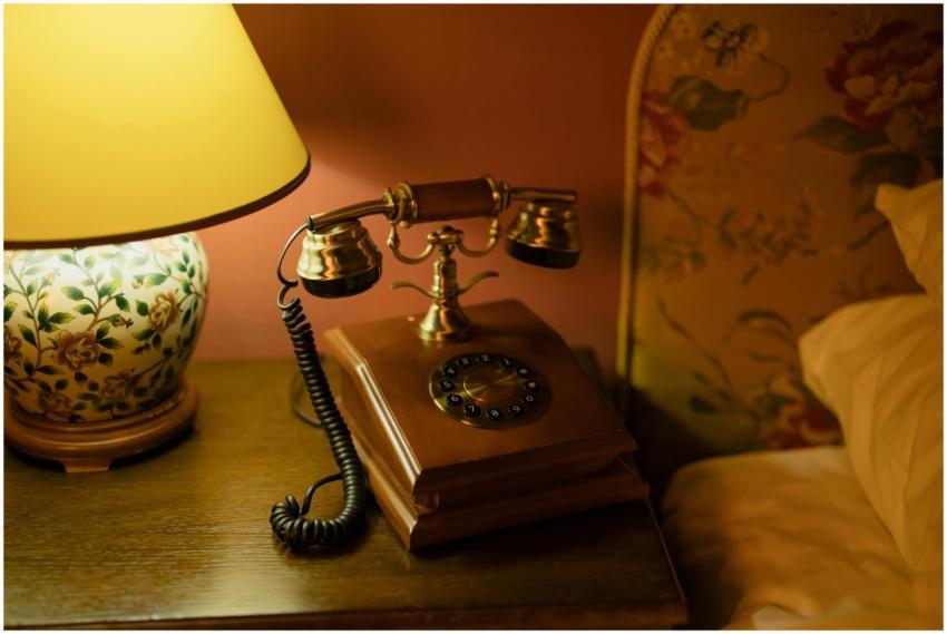 Classic hotel room decor featuring an antique tele