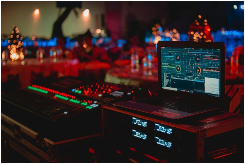 Vivid DJ setup with laptop and sound mixer at a li