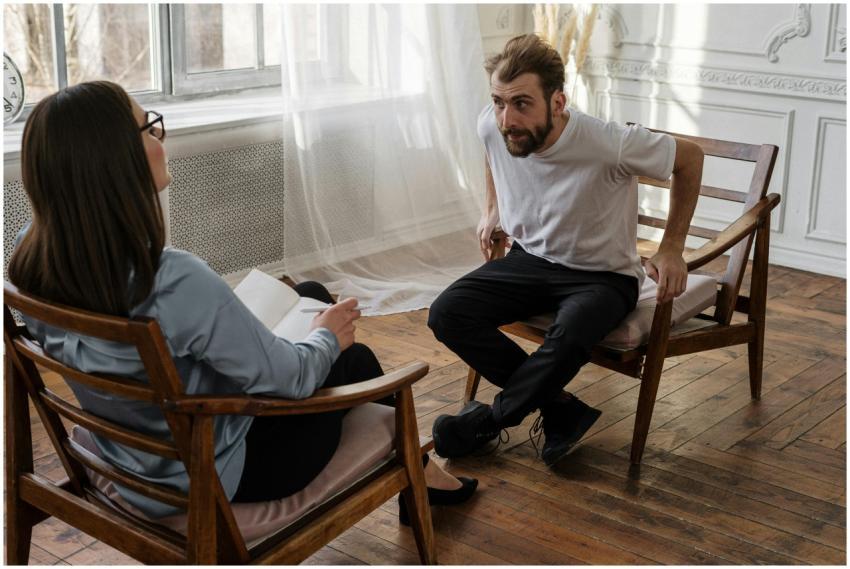 A therapist engages with a male patient in a couns
