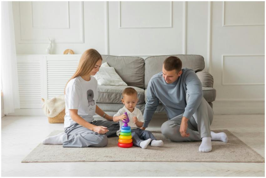 Mom, dad, and young child playing with colorful st