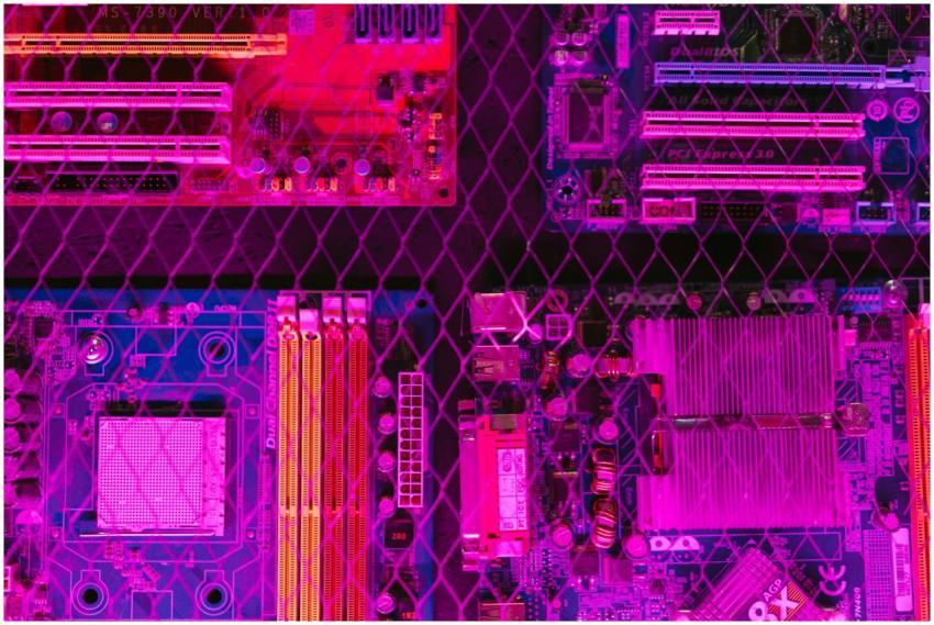Colorful circuit boards behind a wire mesh, enhanc