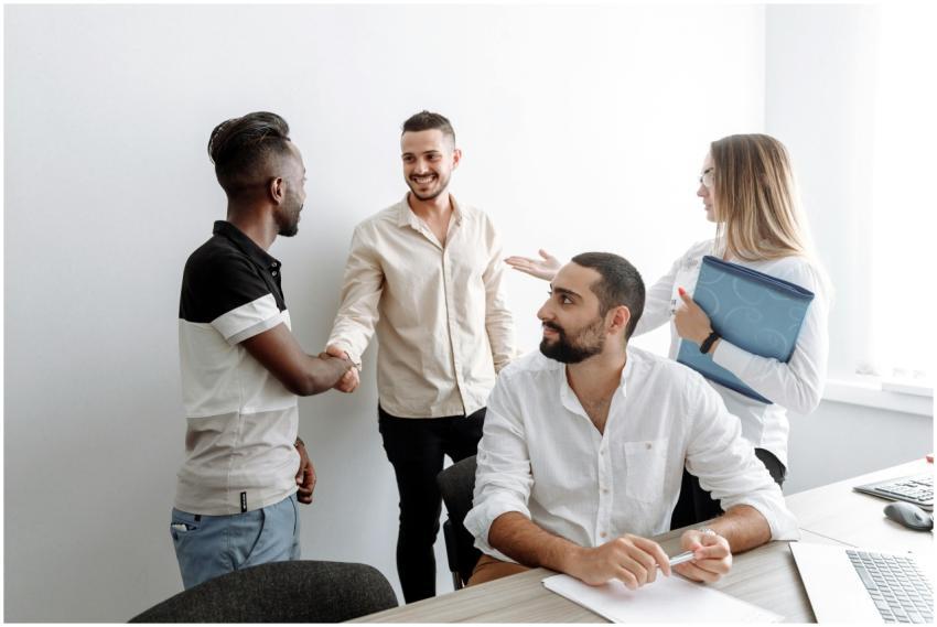 A team of diverse professionals shaking hands and