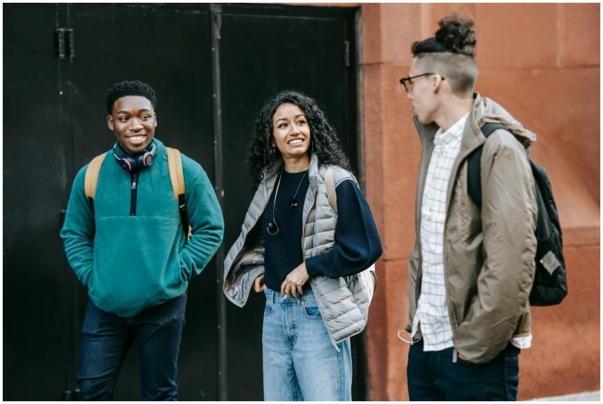 Cheerful multiracial young men and woman in stylis