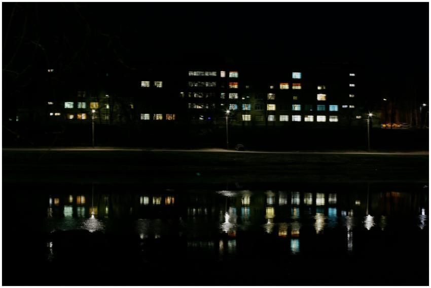 A nighttime shot of an illuminated building with r