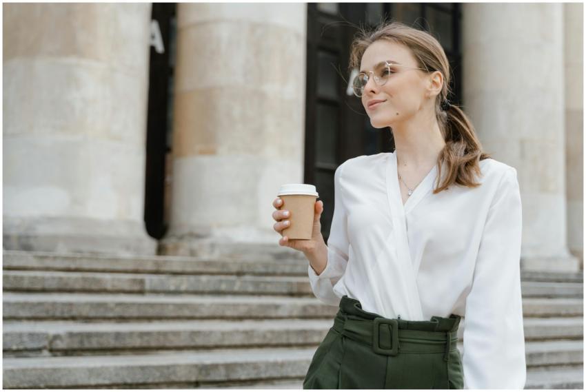 Elegant woman holding coffee cup, enjoying a casua