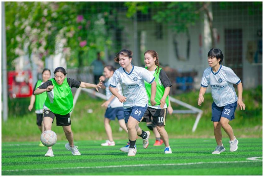 Energetic women playing soccer outdoors in Hanoi,