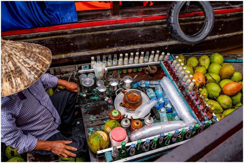 Colorful display of beverages and coconuts at Cần