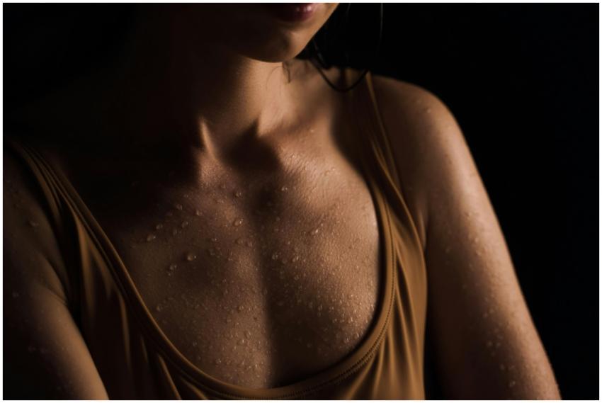 Close-up of a woman's wet skin with water droplets