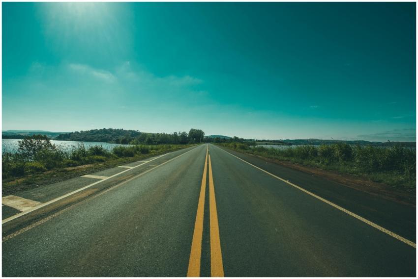 A tranquil highway stretches into the horizon unde