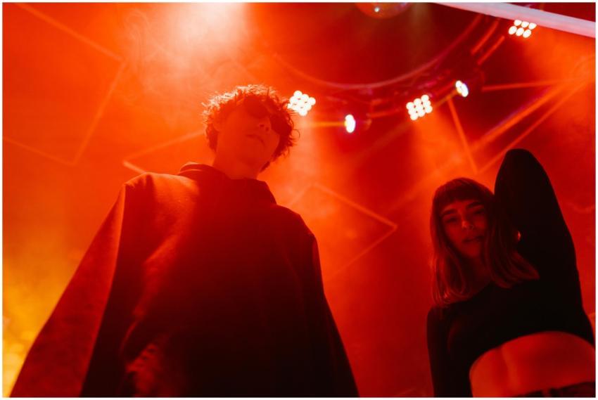 Two young adults enjoying an energetic night at a