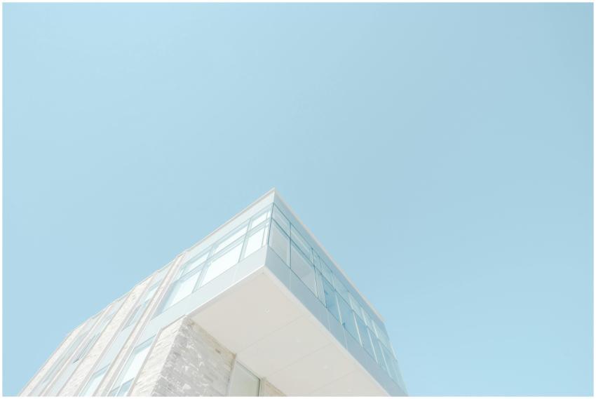 A low-angle shot of a modern building with a glass