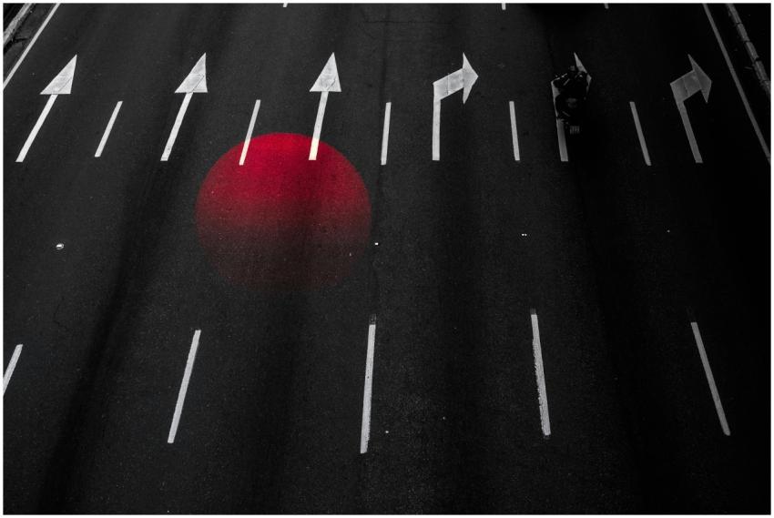 A conceptual asphalt road with directional arrows