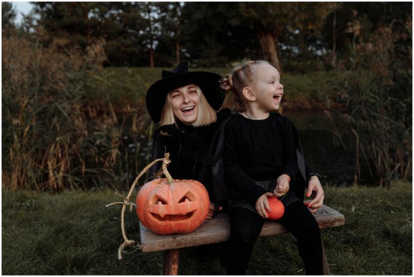 Mother and daughter enjoying Halloween outdoors wi