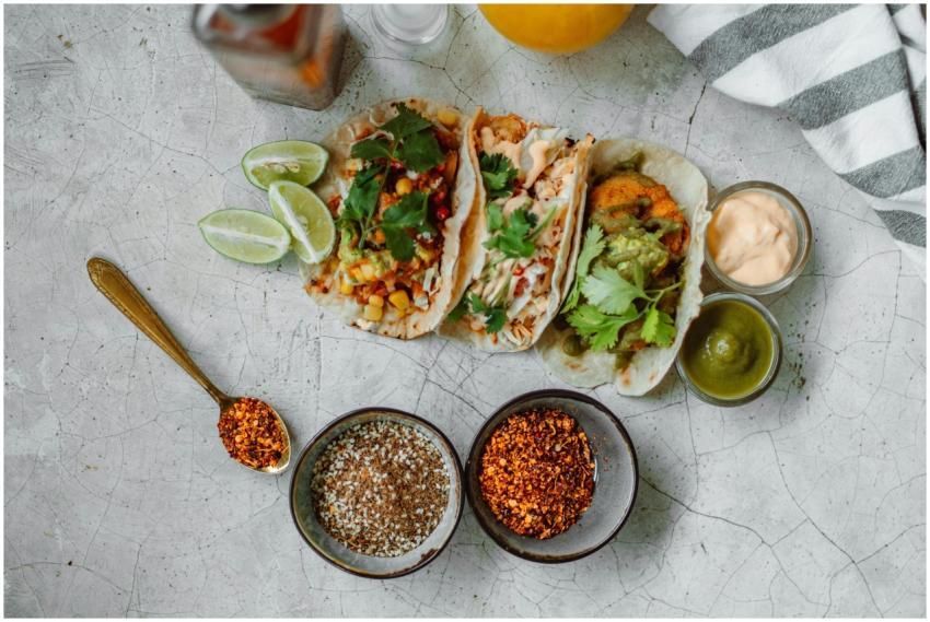 Top view of colorful Mexican tacos with limes, spi