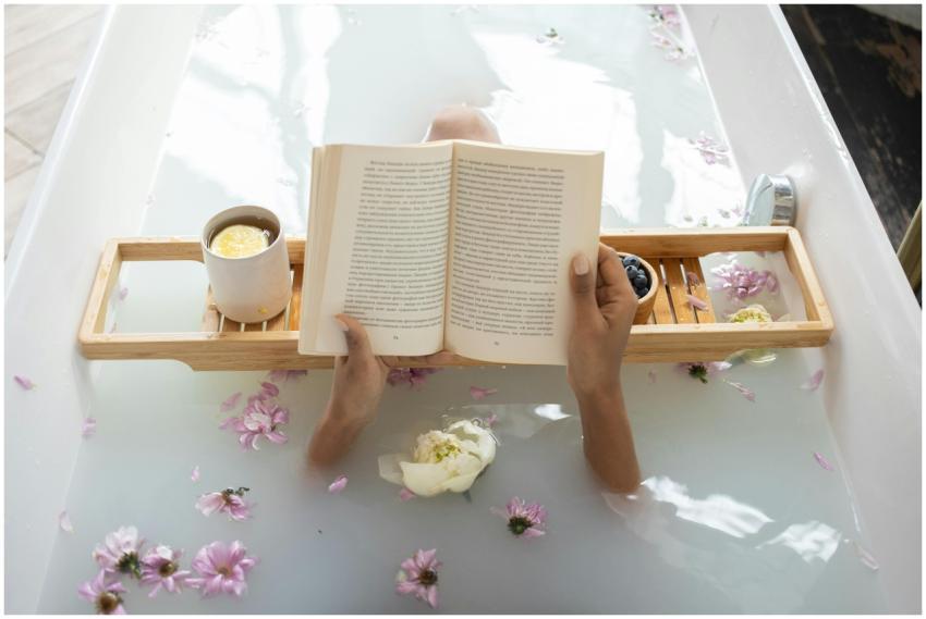 Enjoy a tranquil bath with a book surrounded by fl