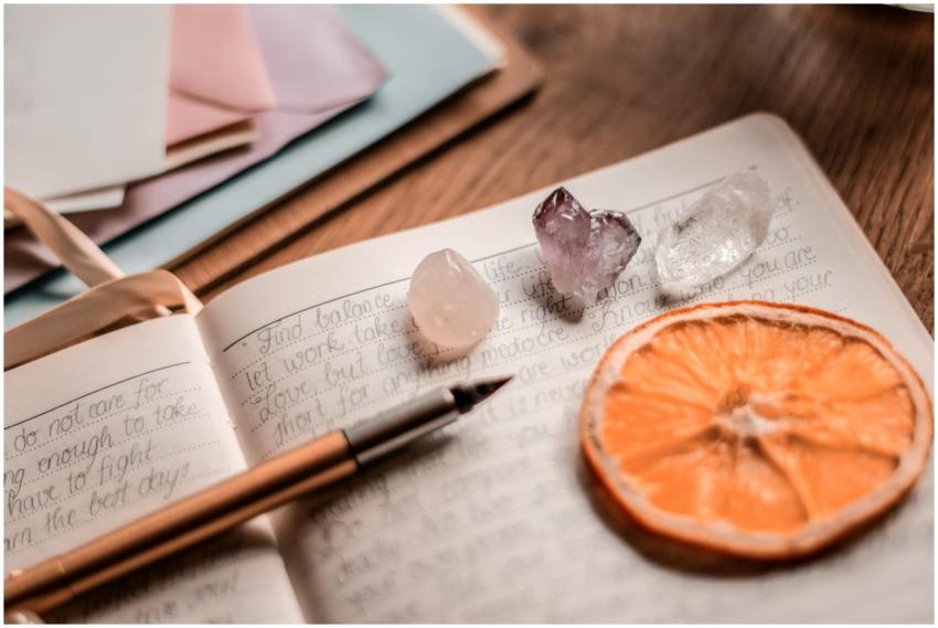Aesthetic journal scene featuring crystals, a pen,