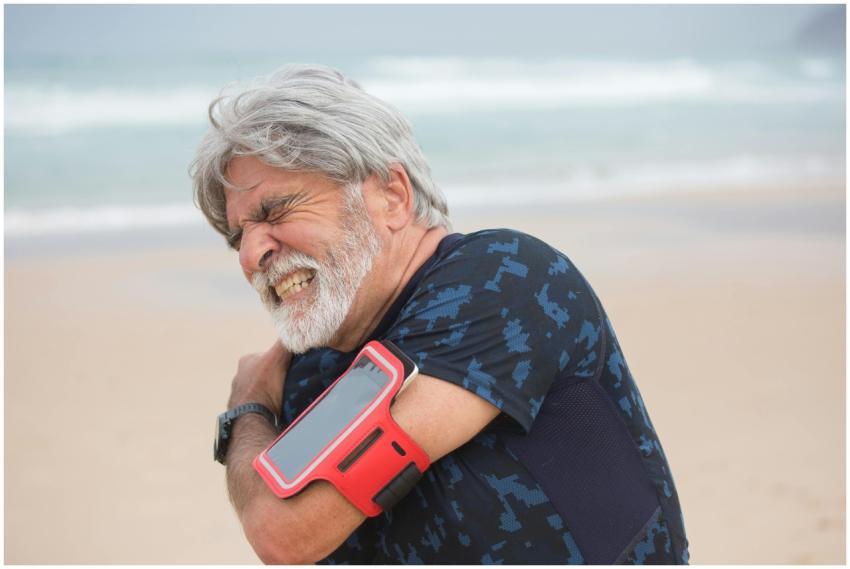 Elderly man grimacing from shoulder pain during se