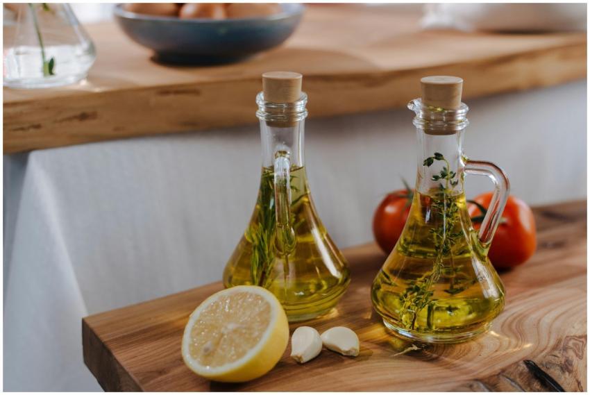 Fresh garlic and lemon with olive oil bottles, per