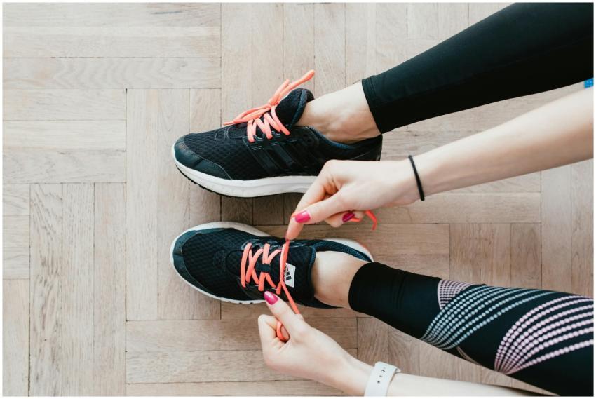 Close-up of a woman tying her sneakers, preparing