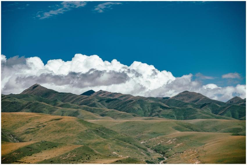 Expansive mountain range with lush green hills and