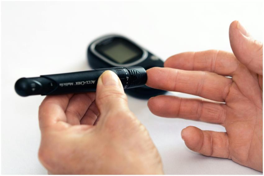 Close-up image of a person using a glucometer for
