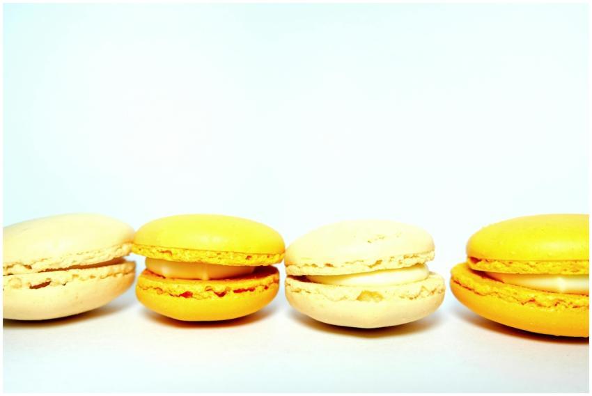 Bright close-up of yellow and cream macarons again