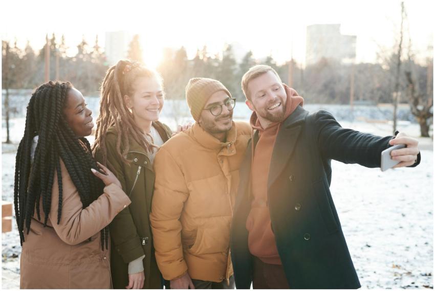 Friends enjoying a snowy day taking a cheerful sel