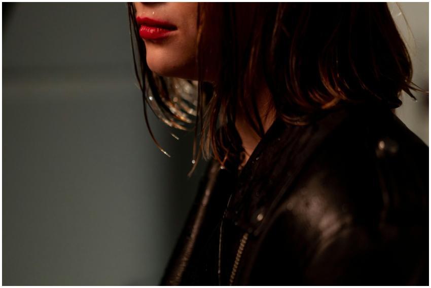 Close-up portrait of woman with red lips and wet h