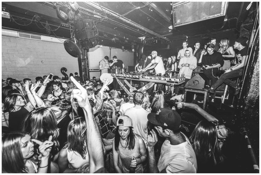 Vibrant nightclub scene with DJ and dancing crowd