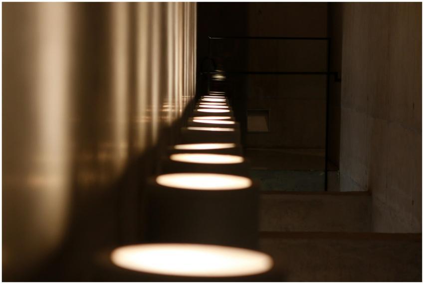 A dark, modern hallway showcasing dramatic lights